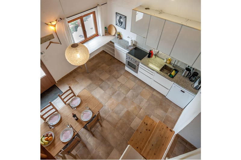 Kitchen and dining table as seen from the upper loft